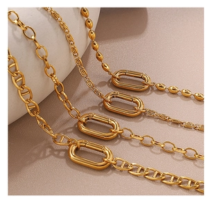 Detailed close-up of 18K gold-plated stainless steel necklaces with large oval spring clasps