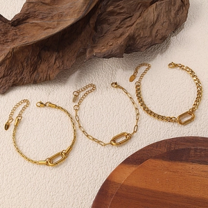 Three gold stainless steel layered bracelets with double-ring clasp on a white background