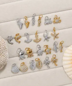 Detailed array of ocean-themed jewelry pendants with sparkling zircon in gold and silver