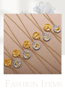 Detailed relief of 18K gold zodiac coin pendants with star charms on O-shaped chains