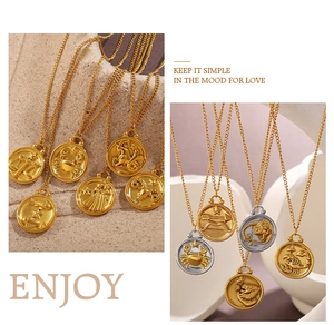 Detailed macro view of 18K gold and silver zodiac pendant necklaces on textured stands