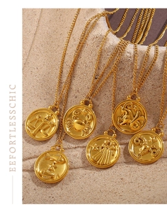 Detail showing vintage 18K gold plated zodiac coin pendants with embossed relief patterns
