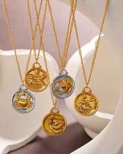 Detail of 18K gold plated zodiac coin necklaces showing embossed astrological patterns