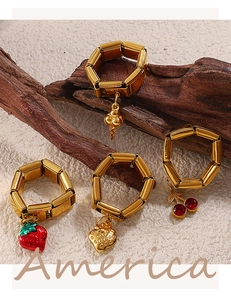 Detail of 18K gold plated stainless steel link ring with strawberry and cherry charms