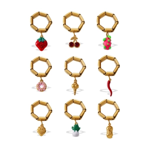 Set of nine 18K gold plated stainless steel rings featuring colorful fruit and food charms