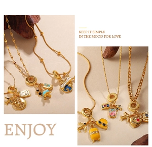 Detailed shot of gold-plated travel necklaces featuring airplane, globe and enamel camera charms