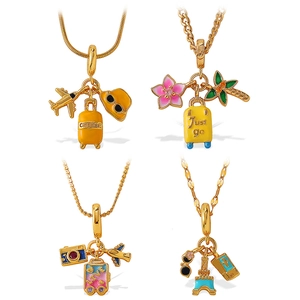 Travel-themed gold pendant necklace set featuring airplane, suitcase, and camera charms