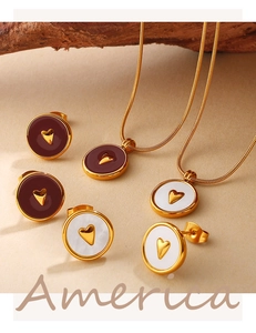 Detail of 18K gold plated heart stud earrings and matching necklace set on beige background