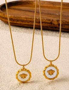 Close-up of 18K gold-plated snake chain necklace with embossed honey bee pendant detail
