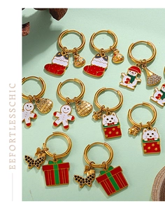 Detail of Christmas earrings featuring enamel gingerbread man, snowman and gift box charms