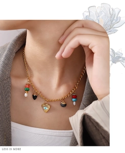 Detail of 18K gold-plated bohemian necklace featuring heart evil eye and colorful beads