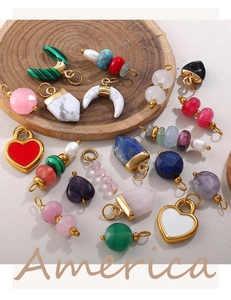 Macro view of colorful heart and crescent moon natural stone pendants with 18K gold hooks