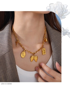 Detail of vintage 18K gold-plated chunky chain necklace with heart and Venus pendants