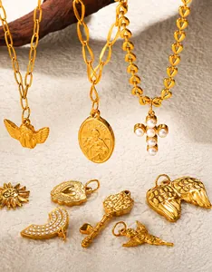 Macro detail of assorted vintage 18K gold plated charms with shell and pearl textures