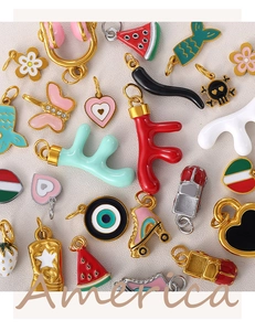 Macro shot of colorful enamel 18K gold-plated pendants with various DIY charms and shapes