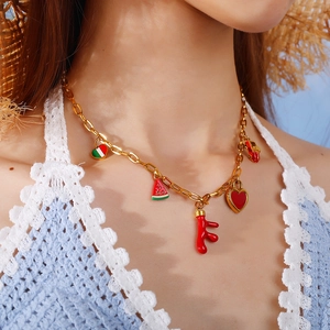 Gold-plated chain necklace with colorful summer charms on a model with beach aesthetic