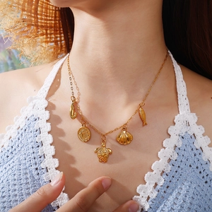 Gold ocean-themed necklace featuring sea turtle, starfish, and shell pendants for summer