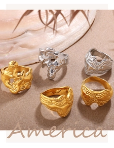 Detail of artistic irregular lava and fluid wave rings in gold and silver finishes
