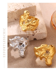 Artistic lava texture rings in gold and silver finish on a rustic stone background