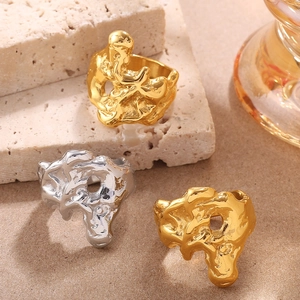 Irregular lava style rings in gold and silver finish on a minimalist stone surface