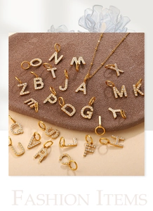 Detailed close-up of 26 18K gold-plated letter pendants with sparkling cubic zirconia
