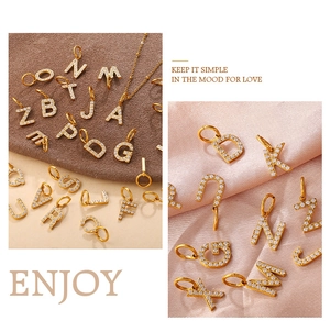 Macro detail of 26 alphabet gold plated pendants with sparkling cubic zirconia pavé