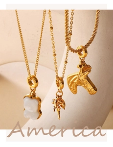 Detail of 18K gold plated necklaces featuring bear, fairy and horse head pendants
