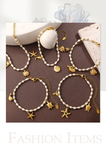 Detail of 18K gold-plated ocean bracelets with pearls, starfish, and sea turtle charms