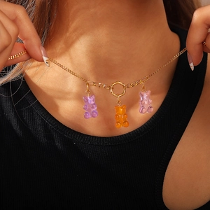 Golden chain necklace with three colorful translucent resin gummy bear pendants