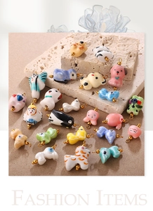 Detail of handcrafted ceramic animal charms for DIY jewelry and phone accessories