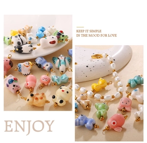 Detailed view of handmade ceramic animal charms with vibrant glazes and golden rings