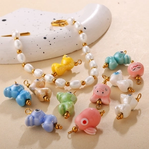 Handmade ceramic animal charms and baroque pearl necklace with gold bead accents