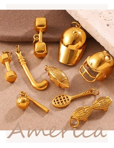 Detailed macro view of gold sport themed charms including dumbbell and tennis racket