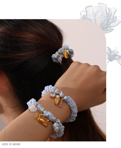 Detailed close-up of blue scrunchies with gold crab and ice cream charms