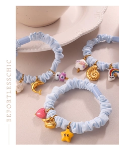Detail of light blue scrunchies with starfish, heart and seashell metal charms set