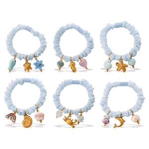 Set of 6 light blue scrunchies with marine charms like turtles and starfish