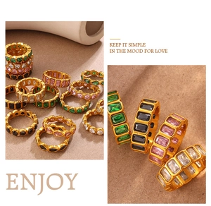 Detail of vintage gold rings set featuring emerald, heart, and pear shaped colorful stones