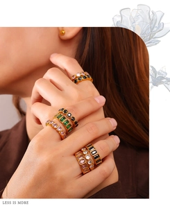 Detail view of gold-plated rings with multi-colored heart and square gemstones