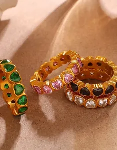 Detailed macro shot of gold plated heart shaped gemstone rings in multi color settings
