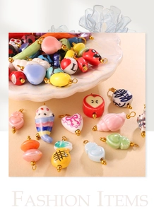 Detailed close-up of mixed ceramic charms like hearts and chili for DIY jewelry making