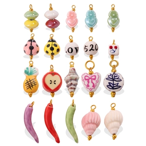 Assorted handmade ceramic charms including heart, ladybug and fruit for DIY jewelry making