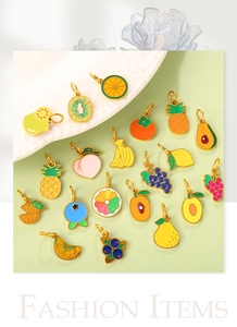 Detail shot of assorted colorful fruit enamel charms like lemon and peach for jewelry making