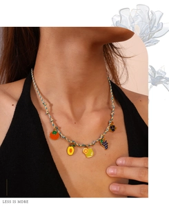 Colorful braided rope necklace with multiple fruit pendants including lemon and grape charms