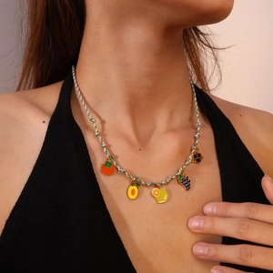 Colorful hand-woven fruit necklace featuring enamel orange, lemon and grape charms
