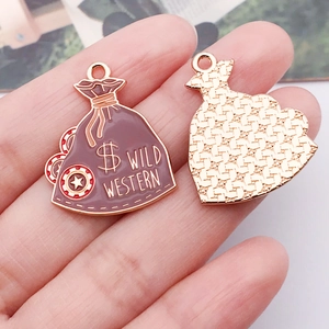 Detailed macro view of gold-tone Wild Western money bag pendant with brown enamel