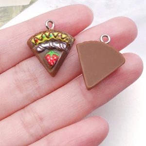 Detailed macro view showing both sides of a resin chocolate strawberry cake pendant