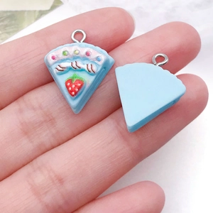 Detailed view of handmade resin strawberry cake charm with silver metal eyelet hook