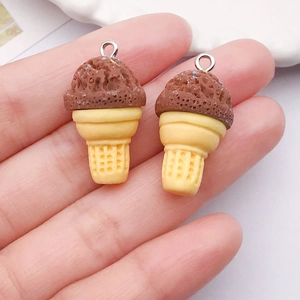 Macro detail of DIY resin ice cream charms with silver metal rings and cone texture