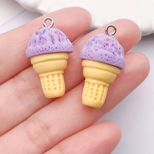 Detailed macro of lavender resin ice cream cone charms with silver metal rings for DIY jewelry