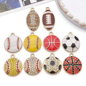 Close-up of enamel sport charms featuring football, soccer and basketball with rhinestones